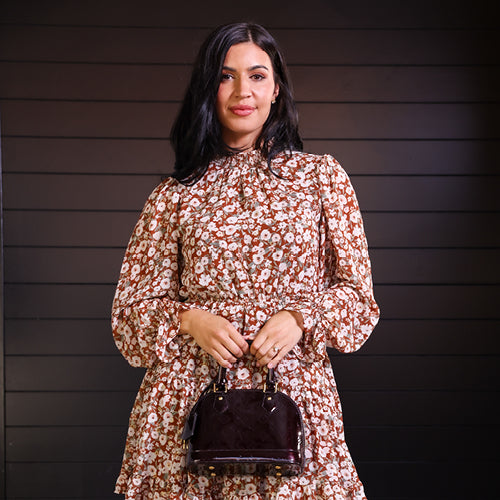 woman in floral dress holding handbag